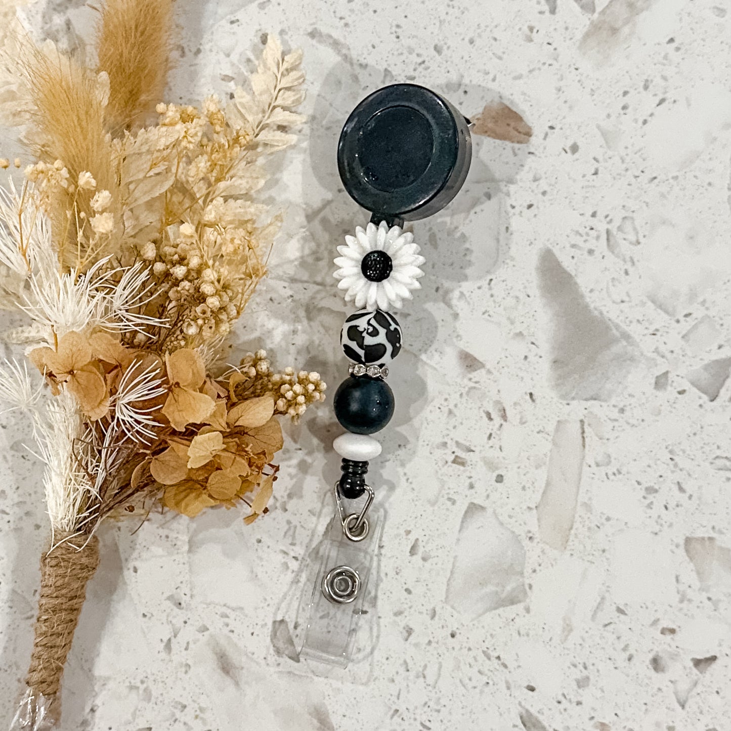 Daisy Badge Reel | Black Moo